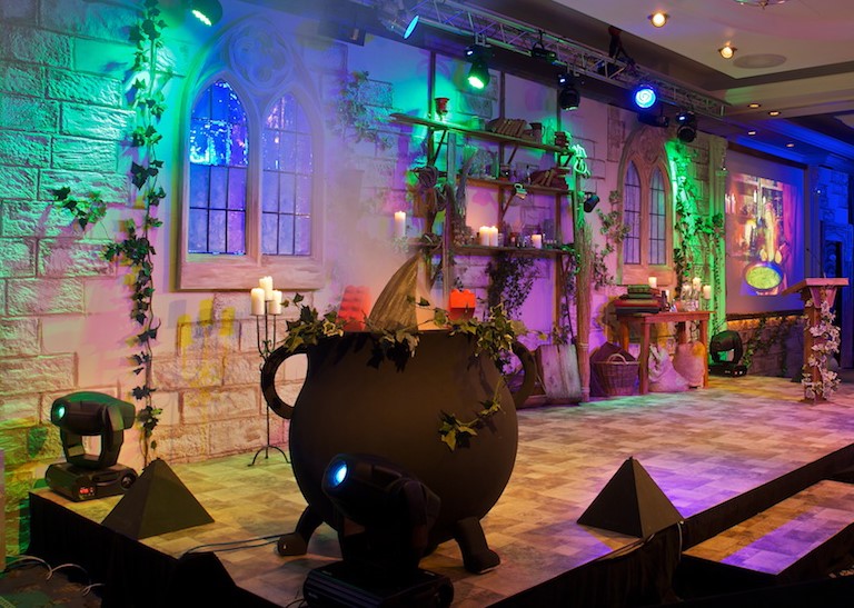 A conference stage design including a large cauldron in the foreground.