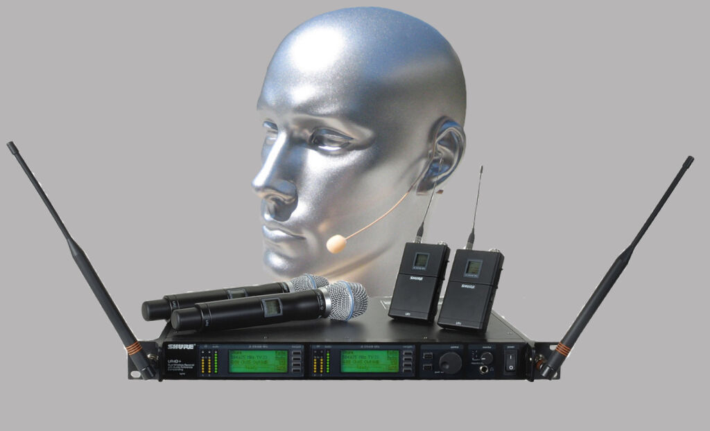 Radio mics and audio equipment modelled on a silver mannequin head to illustrate the work of an event production company like Conference Craft specialising in conference audio hire and corporate event production.