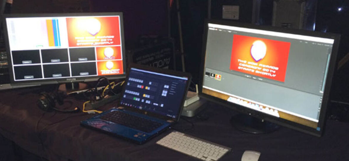 Laptop and screens on a table of equipment showing an example of Conference Craft's technical event management services