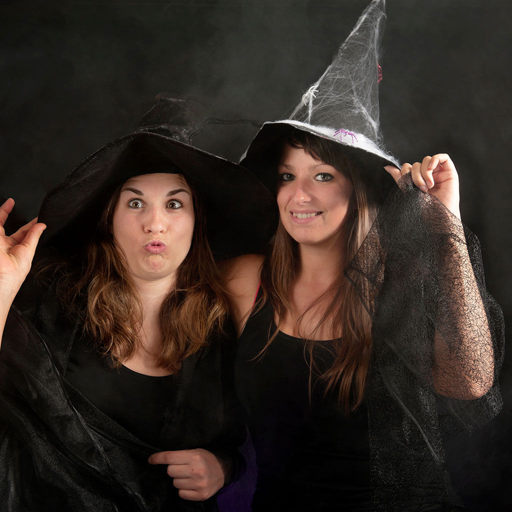 An example of corporate event production with two young women attendees at a team building event in Halloween themed fancy dress.