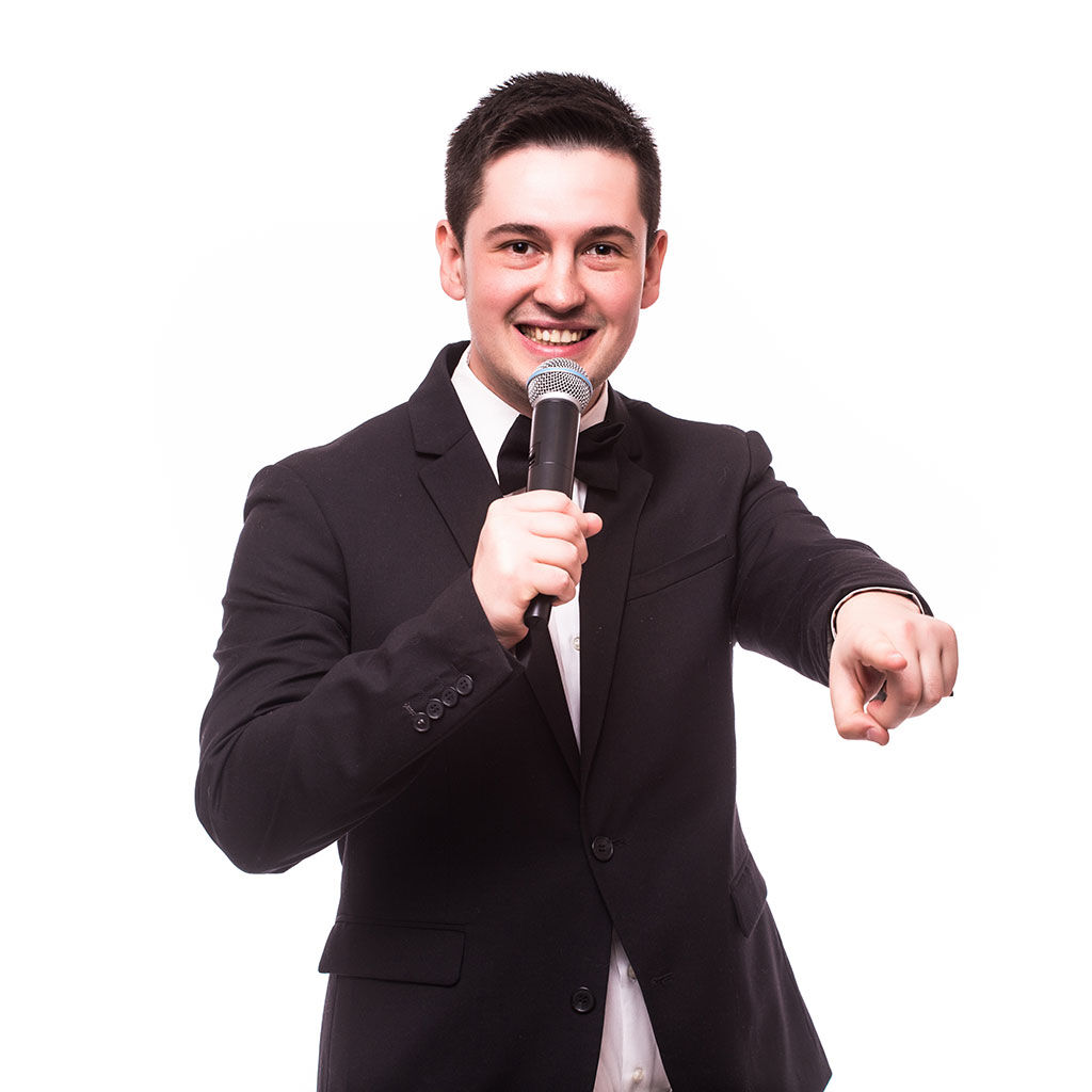 An example of corporate event production with a young man compere holding a microphone at a team building event.