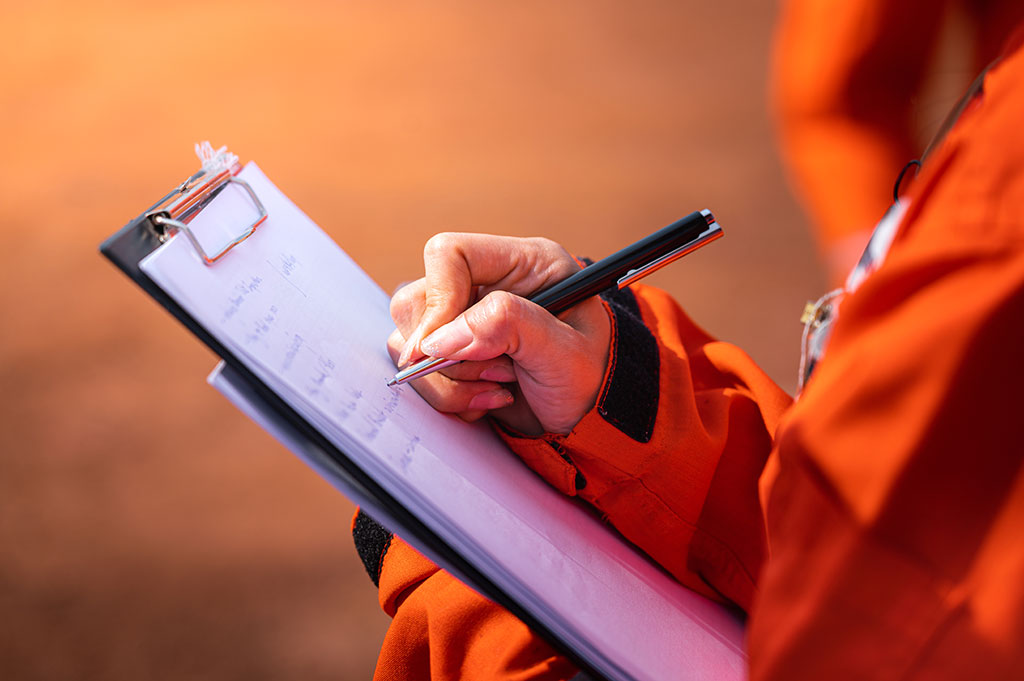 A close up of a contractor carrying out a safety check as is required by a corporate event production company.