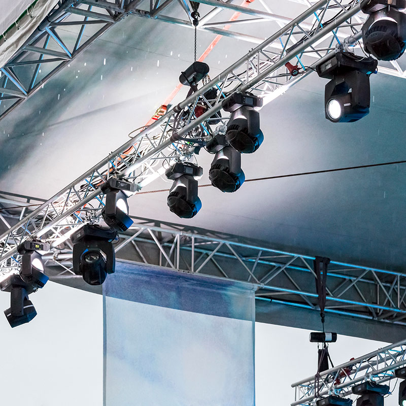 Battern bar above a conference stage design holding a number of spotlights to illustrate conference equipment hire.