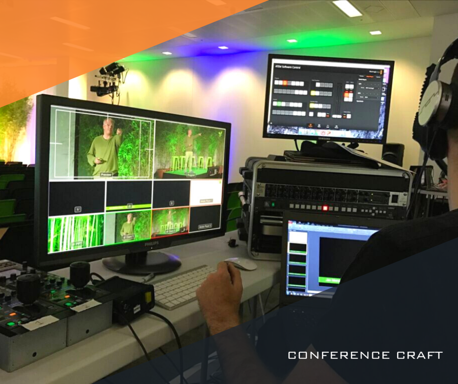 A sustainable corporate event being monitored by a man wearing headphones, reviewing a bank of audio visual equipment.